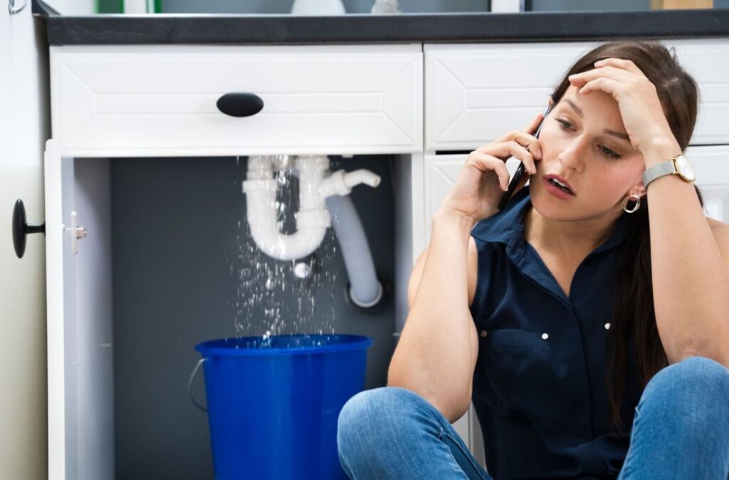 Woman Calling for help for her plumbing problem